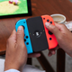 The Enerjoy battery being used as a replacement for the Joy-Con grip accessory.